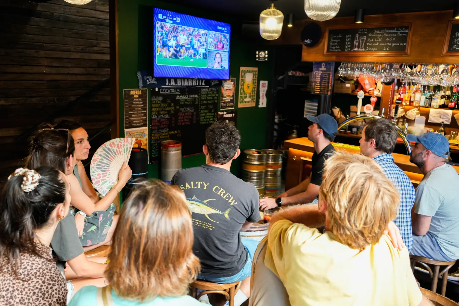 Fans packed around the bar at Molly’s Pub, a rugby match on the screen